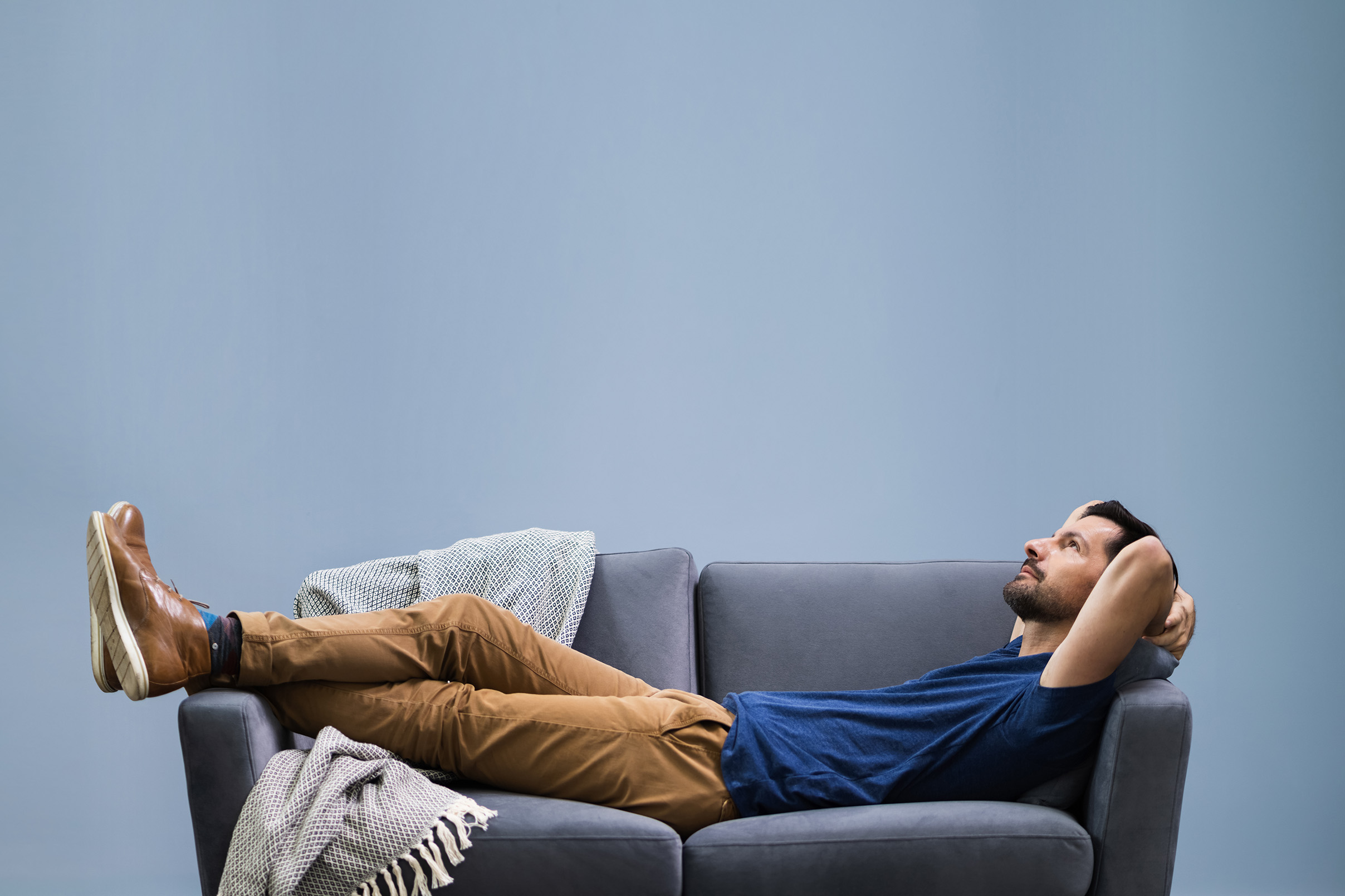 young man lying on a sofa